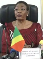 Dinga Dzondo sitting with a small Congolese desk flag in front of her.