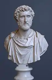 Bust of a bearded man with curly hair wearing a toga.