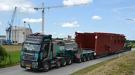 Volvo tractor with drop deck configuration moving oversize load.