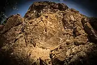 The relief is located at a height of 16 meters, on the top of a cliff towering over the village of Sarpol-e Zahab. A second relief (relief of Gotarzes II, Parthian Empire) appears below.