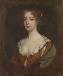 Portrait of woman with should length curly black hair and pearl necklace