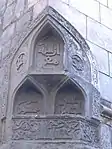 Beveled or chamfered corner of the mosque with three muqarnas niches.