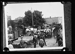 Workers taking cement slabs from railway station to the ARC village at Pisa.