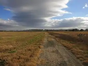 Duke Road is fenced off where it crosses Houston Southwest Airport property. Duke was located just beyond the BNSF Railway freight train in the distance.