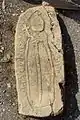 Decorative tombstone depicting a bishop near the southern façade the church.