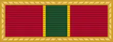 A red ribbon with four vertical dark green stripes in the center.