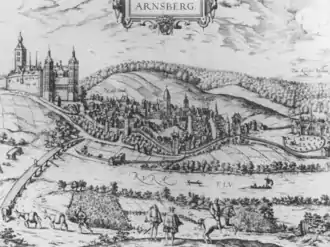 View of a castle, a small town at the bottom of a mountain, and a monastery. A sign in the upper part of the illustration says "Arnsberg". In the foreground, two men, presumably the lord of the castle and a visitor, watch a horse and rider depart; in the middle ground, a "new" bridge spans a river, labeled Rurh, (the old one is in ruins slightly to the left). A castle with three towers and crenelated walls is on the left, the town in the middle, on the slope of a hill, and a monastery (so designated by crosses) is on the far right.