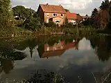 View across the pond in the centre of the village