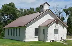 Low church building with gable roof, small belltower