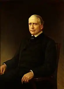 oil on canvas portrait of a silver and gray-haired Senator Gorman, wearing a dark suit and seated toward the left against a dark background, facing the viewer with a soft smile on his lips