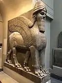 Lamassu, initially depicted as a goddess in Sumerian times, when it was called Lamma, it was later depicted from Assyrian times as a hybrid of a human, bird, and either a bull or lion—specifically having a human head, the body of a bull or a lion, and bird wings, under the name Lamassu.