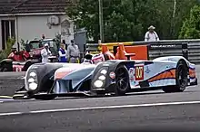 A LMP1 Aston Martin sports prototype being piloted on a racing circuit