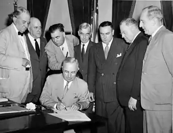 President Harry S. Truman signs the Atomic Energy Act of 1946