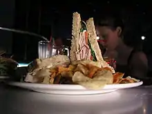 A club sandwich and potato chips on a plate at the Sci-Fi Dine-In