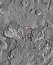 THEMIS image of wide view of following HiRISE images. Black box shows location of HiRISE images.  Image is part of the Aureum Chaos. Click on image for details.