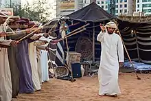 Image 18A band performs the Ayyala, which is a cultural dance derived from Arab tribes sword battles. (from Culture of the United Arab Emirates)