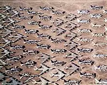 Aerial view of B-52s and other aircraft slowly being scrapped in the desert.