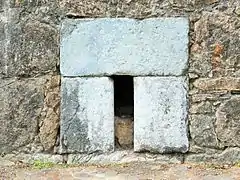 Detail of spillway or sewer in the lower part of a curtain wall