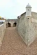 Westerly angled curtain walls, bartizan and moat