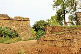 Curtain wall of the bastion, old defensive walls and, in the middle, the moat