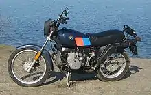  Black BMW R80G/S parked in front of a lake