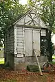 Old wooden mortuarium built in the early 19th century in neoclassical style for the cemetery situated against the dijk.