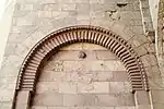 Blind arch with "cushion" voussoirs on the inner side of the flanking towers