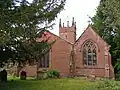 View of the church from the east, showing Capel Cures' north chapel to the right.