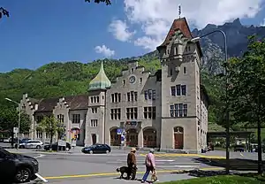 Three-story stone building with arched roof and tower