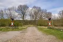 Level crossing to the former loading area and an unmetalled farm track at the western end.