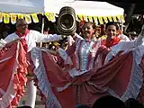 A Cumbia (Colombia) dancer holding a Sombrero vueltiao.