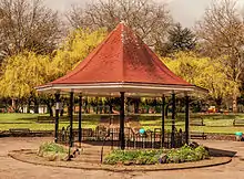 an octagonal structure with a red tiled roof