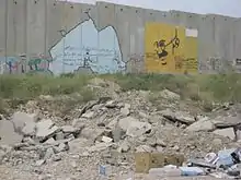 A Banksy, and a mural of Gandhi, Qalandia