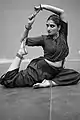 A Bharatanatyam dancer striking a pose during practice