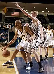 Image 14Navy Midshipmen George O’Garro rounds Army Cadet Steve Stoll in an attempt to score during the Army Navy basketball game in Alumni Hall at the U.S. Naval Academy, Annapolis, Maryland, January 31, 2004