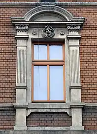 Window with pilasters, pediment and mascaron