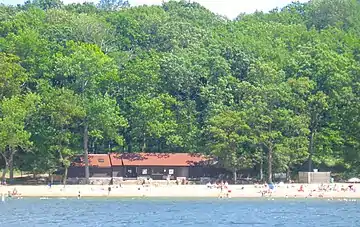  Building with beach on lake.