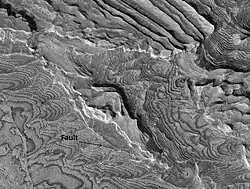 Becquerel crater layers with a fault, as seen by HiRISE.