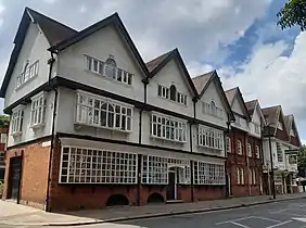 The estate shop, the Bedford Park Stores (with a private house and The Tabard), all by Shaw, 1880
