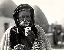 Image 18Syrian Bedouin from a beehive village in Aleppo, Syria, sipping the traditional murra (bitter) coffee, 1930 (from History of coffee)