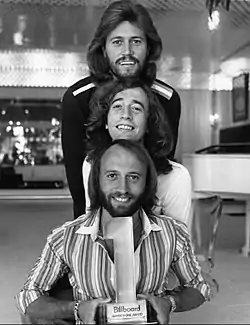 The Bee Gees in 1977 (top to bottom): Barry, Robin, and Maurice Gibb