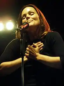 A woman singing into a microphone