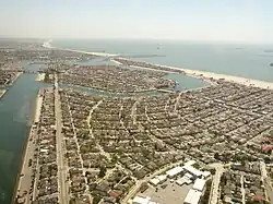 Belmont Park is in the foreground in this photo, with Naples Island is in the middle distance, and The Peninsula and the neighboring city of Seal Beach beyond, looking southeast.