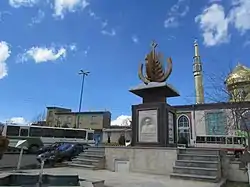 Statue in village square of Benis. The mosque can be seen in the background.