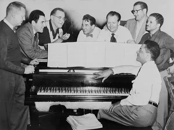 Ziggy Elman with Benny Goodman (third from left) and some of Goodman's former musicians in 1952. Left to right: Vernon Brown, George Auld, Goodman, Gene Krupa, Clint Neagley, Elman, Israel Crosby, and Teddy Wilson (at piano)