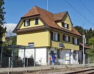 Three-story building with hip roof and gables