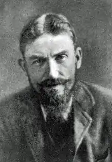 Man in early middle age, with full beard