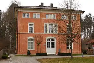 Three-story brick building with hipped roof