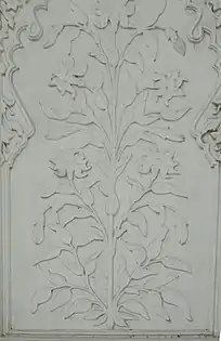 Floral designs on marble, as seen on the tomb's interior walls