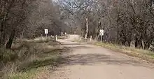 A dirt road with a bridge